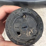 Close-up of your typical sprinkler (rotor) that's been weathered and damaged over the years.