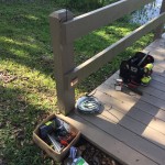 Tools and materials setup for installing deck lights along dock.
